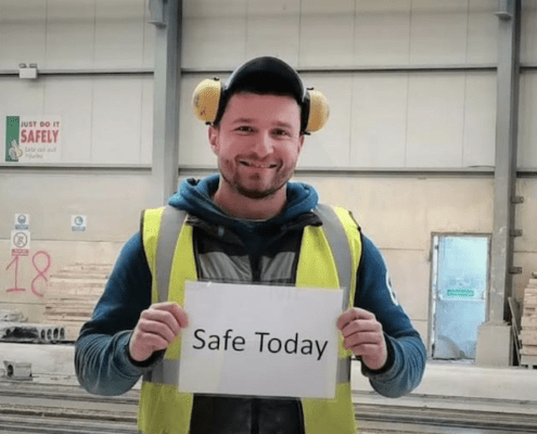 Construction Safety Week 2022 sign held by a worker